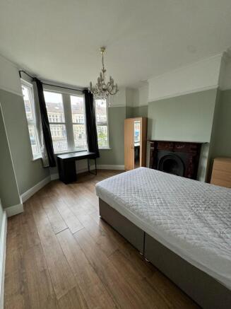 A spacious and bright double bedroom featuring ...