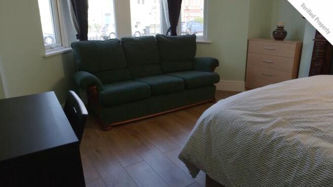 A bright and cozy double bedroom featuring a co...