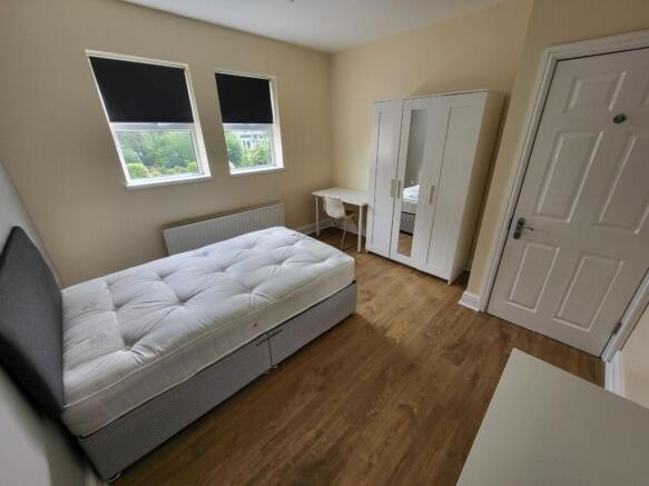 A bright and spacious double bedroom featuring ...