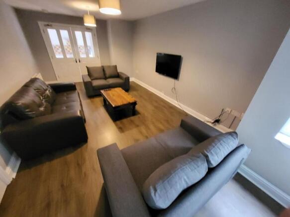 Spacious and inviting living room featuring com...