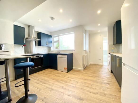This modern kitchen features sleek cabinetry, a...