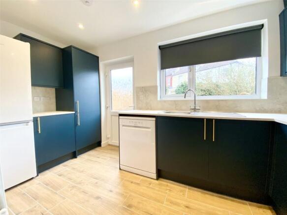 Modern kitchen featuring sleek black cabinetry ...