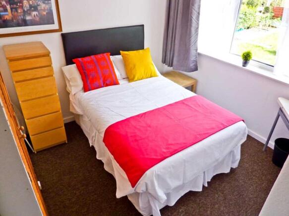 A bright and inviting double bedroom featuring ...