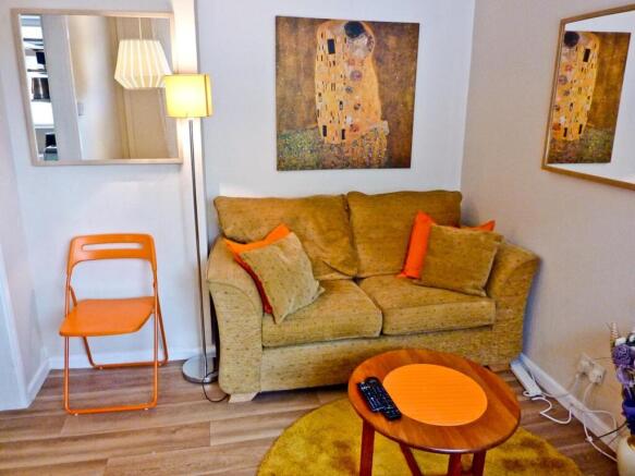 A cozy living room featuring a comfortable sofa...