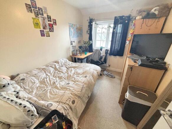 This cozy double bedroom features a comfortable...