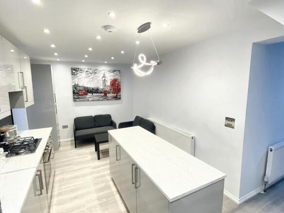 Modern kitchen featuring sleek cabinetry, a spa...