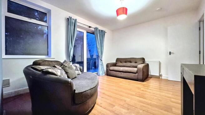 A spacious and inviting modern living room, per...
