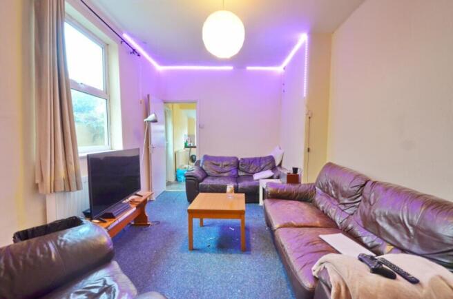 Spacious and inviting living room featuring com...