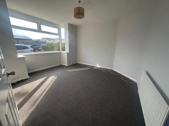 Bright and airy double bedroom featuring a larg...