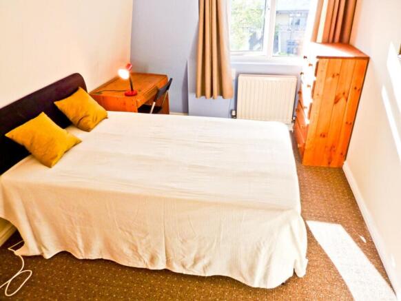 A bright and inviting double bedroom with ample...