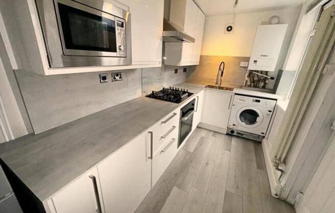 This modern kitchen features sleek cabinetry an...