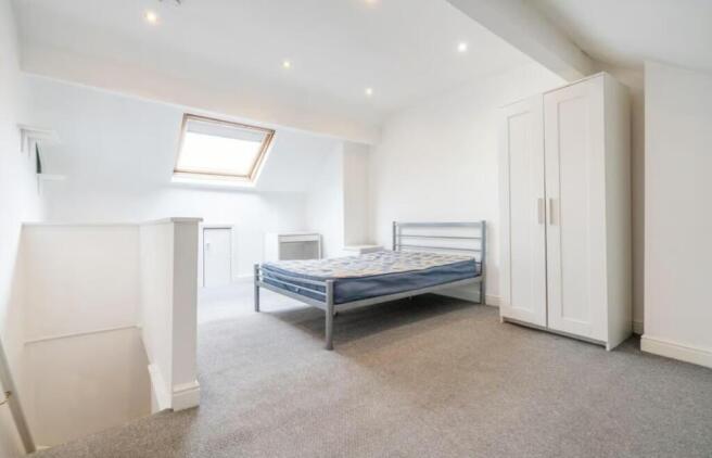 Bright and spacious double bedroom featuring a ...