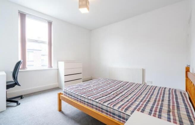 Bright and inviting double bedroom featuring am...