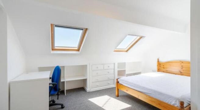Bright and airy double bedroom featuring sloped...