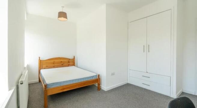 Bright and inviting double bedroom featuring am...