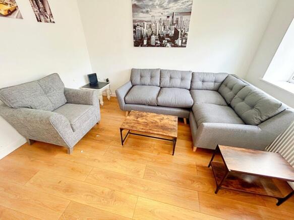 This contemporary living room features a cozy s...