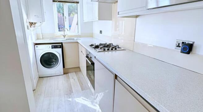 This modern kitchen features sleek cabinetry an...