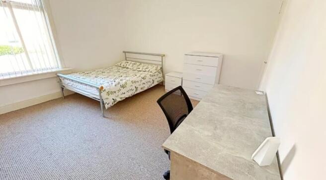 A bright and inviting double bedroom featuring ...