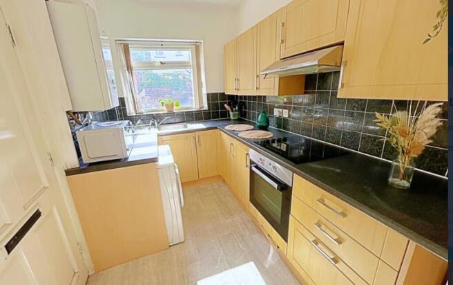 This well-appointed kitchen features modern cab...