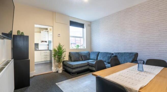 A stylish living room featuring a cozy sofa, a ...