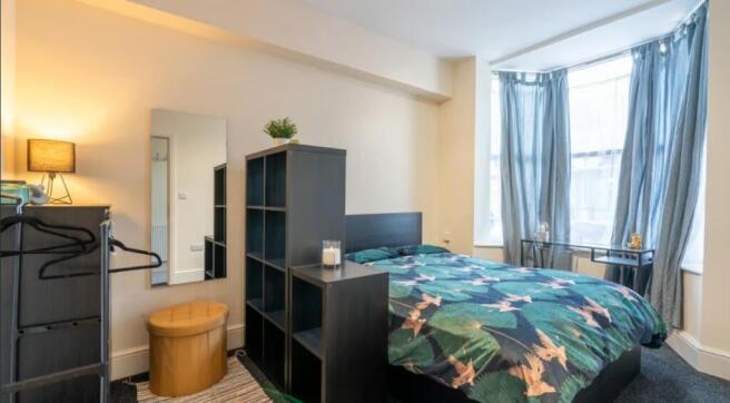 Bright and inviting double bedroom featuring la...