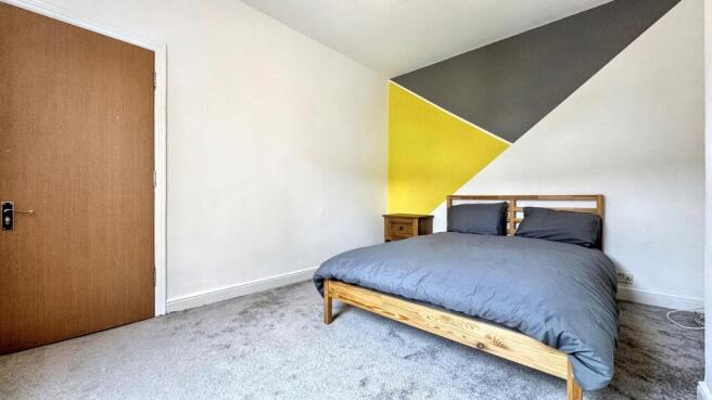 Bright and inviting double bedroom featuring mo...