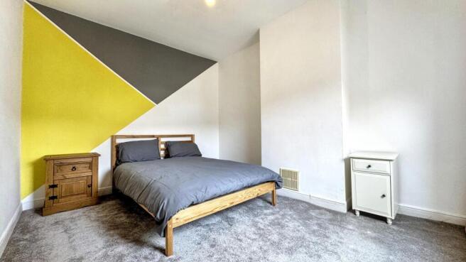 A cozy double bedroom featuring a stylish desig...
