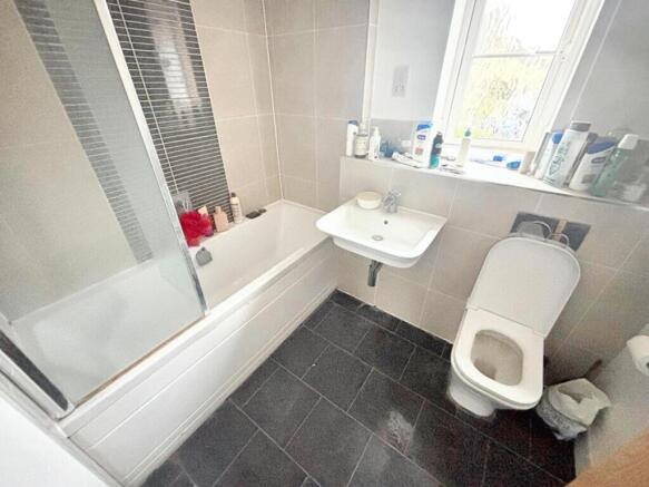 A well-equipped bathroom featuring a spacious b...