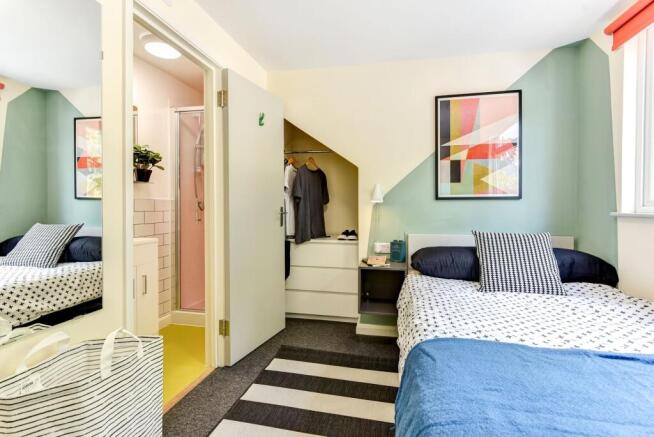 This inviting double bedroom features a cozy la...