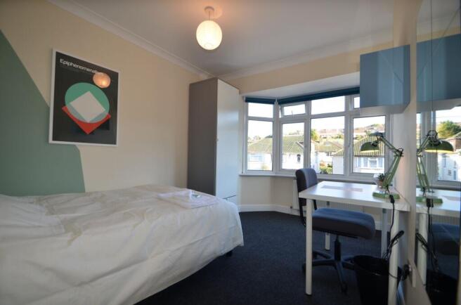A bright and inviting double bedroom featuring ...