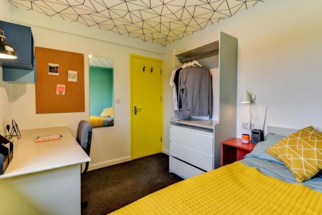 A cozy and modern double bedroom featuring a vi...