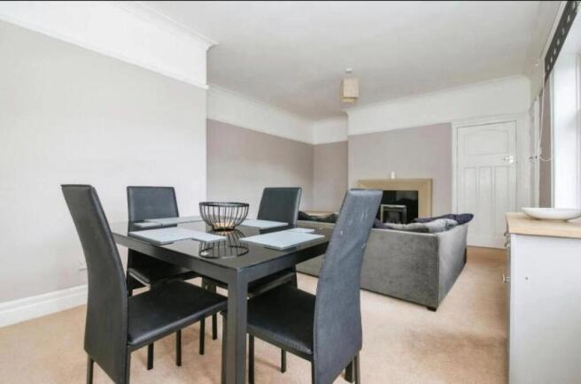 Spacious and inviting living room featuring a m...