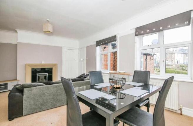 This spacious living room offers a warm and inv...