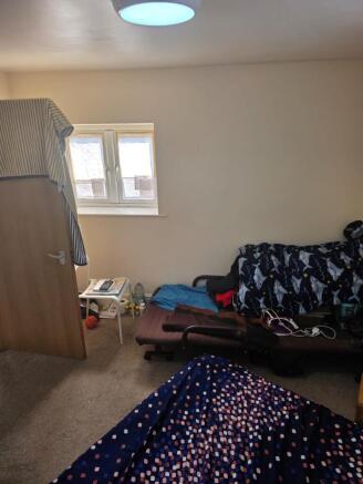 This cozy double bedroom features a comfortable...
