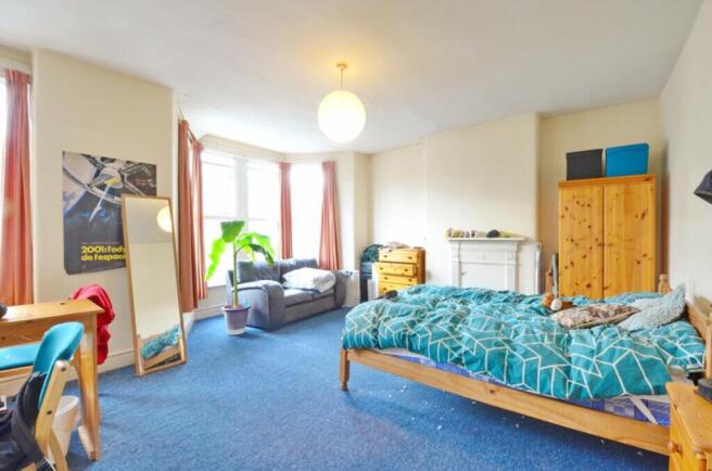 Spacious double bedroom featuring ample natural...