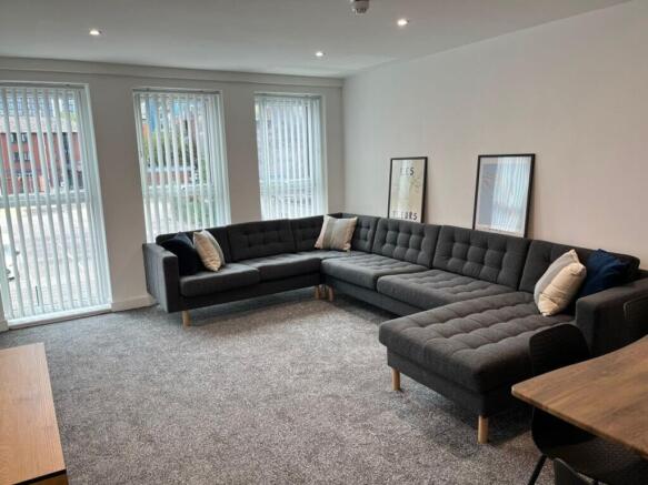 Spacious and inviting living room featuring lar...