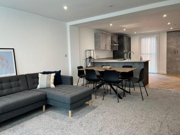 Spacious and modern living room featuring a com...