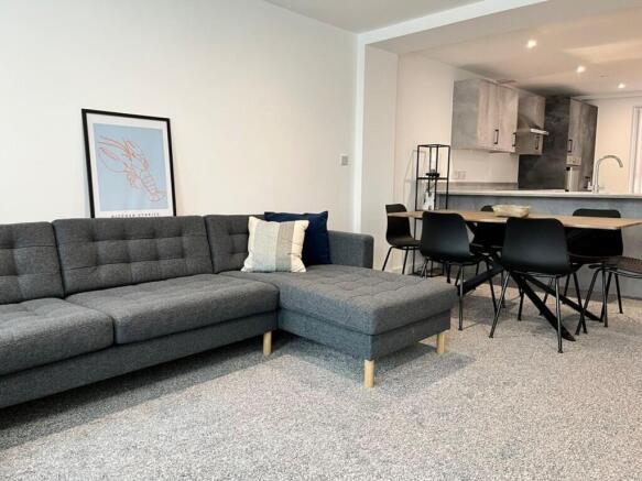 This stylish living room features a modern gray...