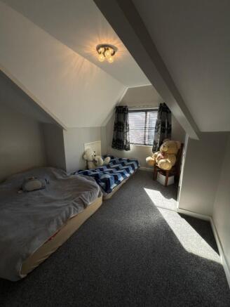 A cozy double bedroom featuring ample natural l...