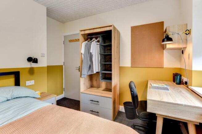 This stylish double bedroom features a cozy atm...