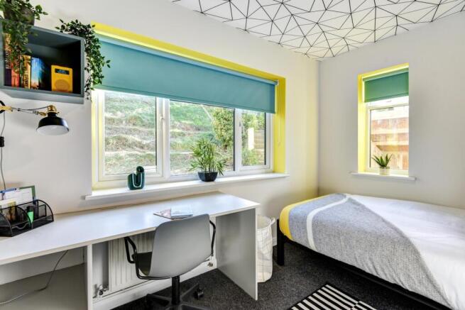 Bright and inviting double bedroom featuring la...