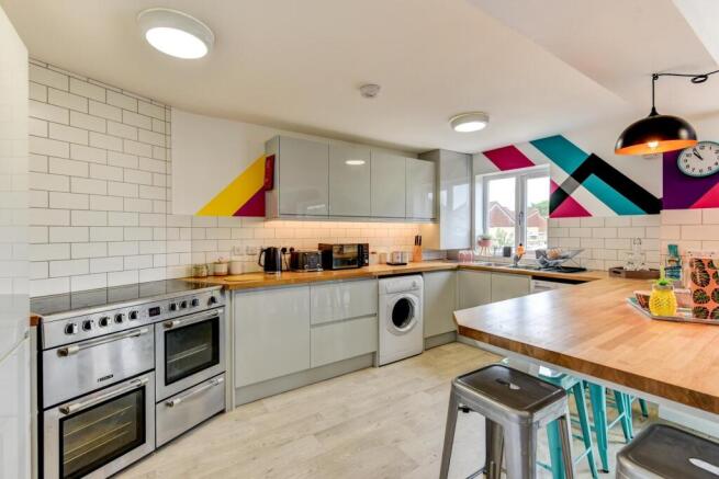 This modern kitchen features sleek cabinetry an...