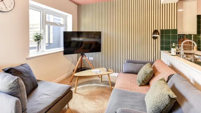 Experience a cozy and stylish living room featu...