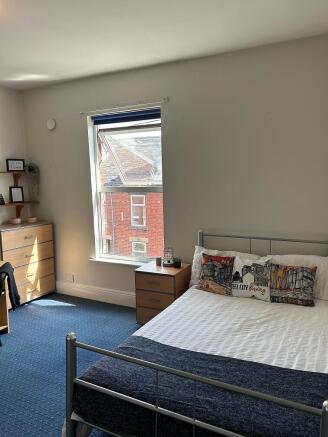 Bright and spacious double bedroom featuring a ...