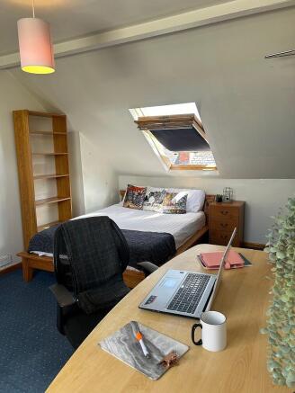This charming double bedroom features a cozy la...