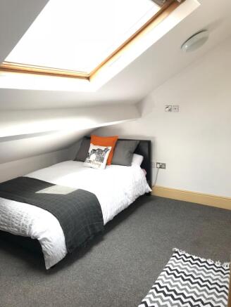 A cozy double bedroom featuring a comfortable b...