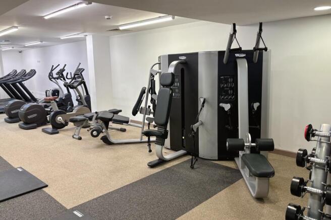 A modern gym space equipped with a variety of e...