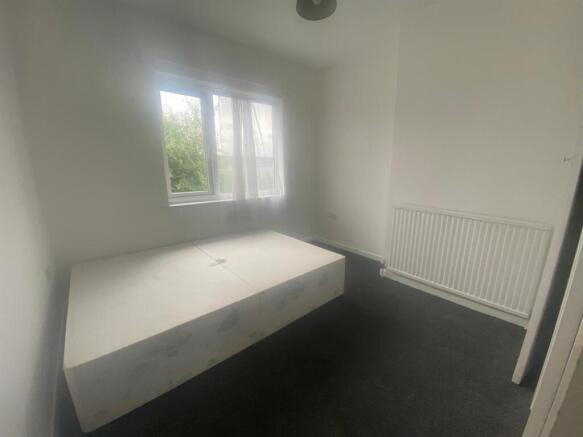 Spacious and bright double bedroom featuring la...