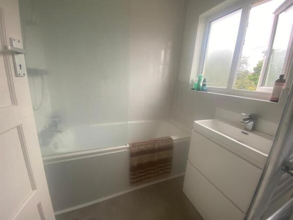 A modern bathroom featuring a sleek design with...