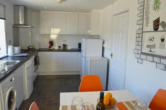 This bright and modern kitchen features sleek c...